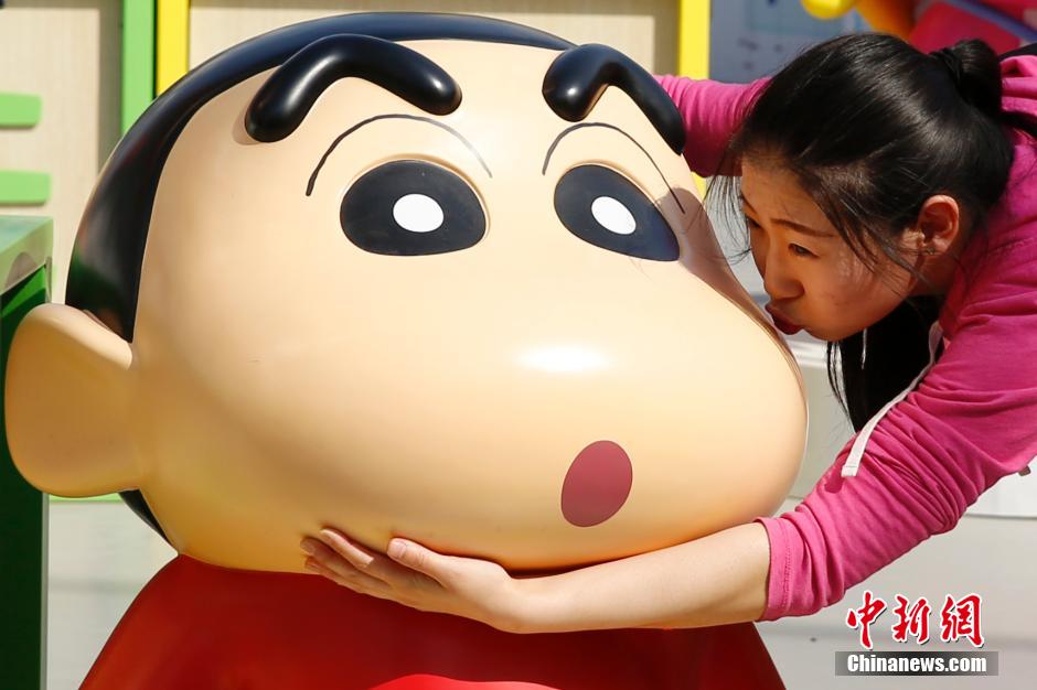 4月22日，游客與蠟筆小新合影?！跋灩P小新25周年紀(jì)念特展”日前在北京開展，吸引了不少市民游客。