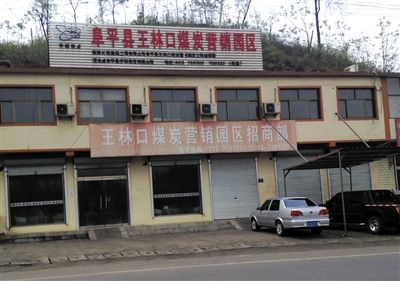 4月23日，王林口煤炭營(yíng)銷園區(qū)招商部窗上還貼著“河北省阜平縣重點(diǎn)工程”的宣傳貼。新京報(bào)記者 張永生 攝