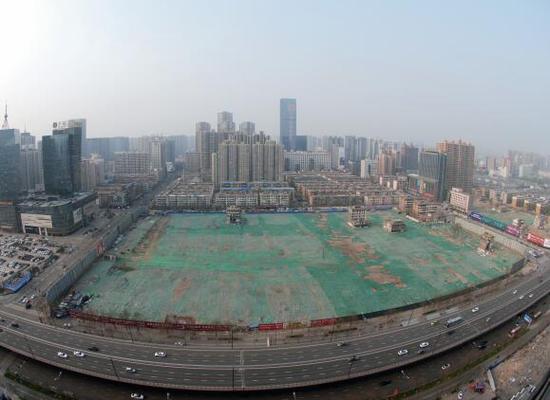 2016年4月，經(jīng)過持續(xù)攻堅，親賢社區(qū)西北片區(qū)的拆遷工作基本告一段落，但在鋪設了防塵綠網(wǎng)的空地中，至今仍有3戶居民選擇了“堅守”。(拍攝：2016年4月4日)