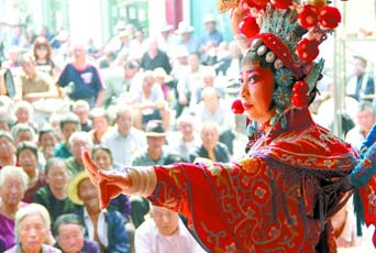 圖為8月15日戲曲演員在“流動舞臺車”上表演傳統(tǒng)地方戲《穆桂英下山》。