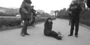 鄭大姐坐在地上，警方趕到進(jìn)行施救。（視頻截圖由警方提供）